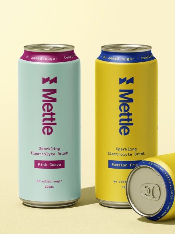 Mettle cans in Pink Guava and Passion Fruit on a pale yellow ground